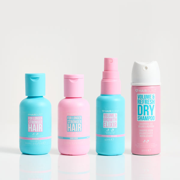 Four hair care products with blue and pink bottles on a white background