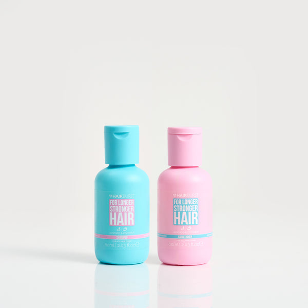 Two bottles of hair care product, one blue and one pink, on a white background.